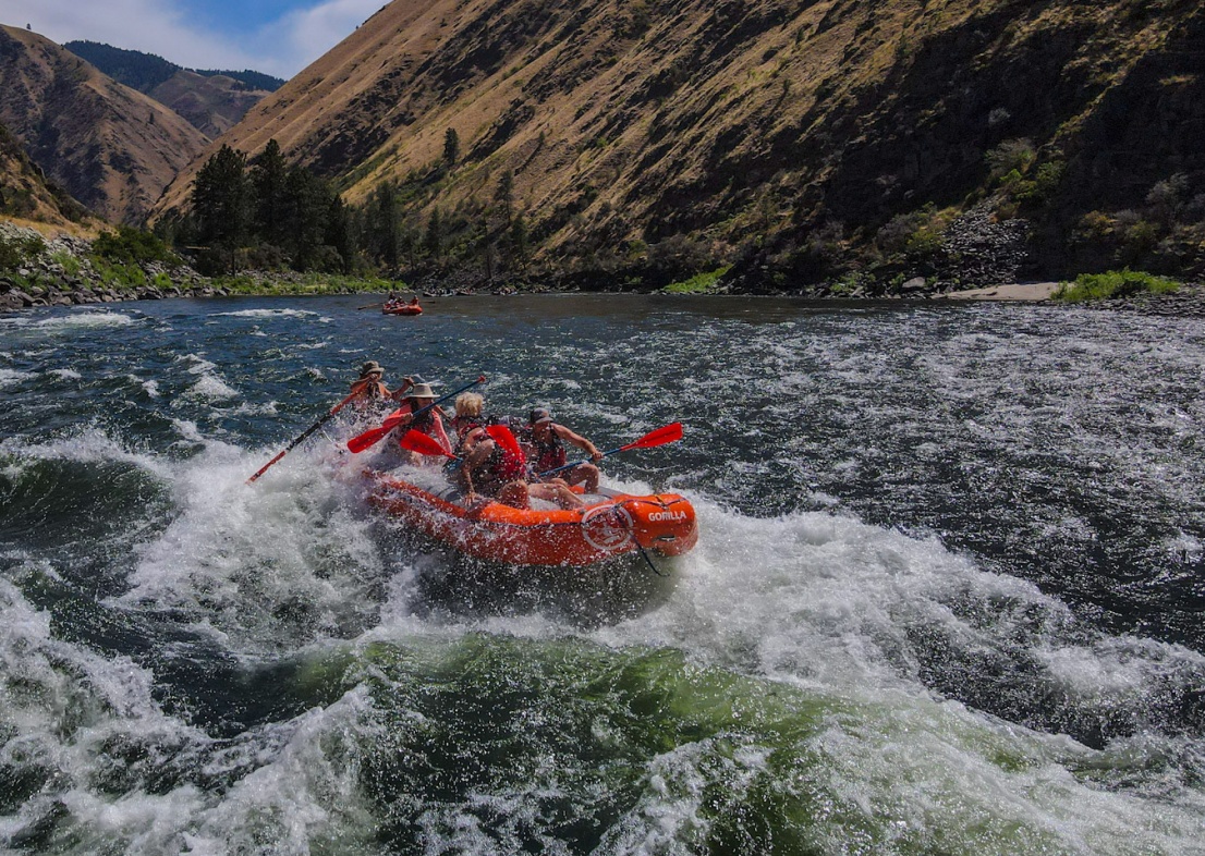 Orange Torpedo Trips raft with guests in traps rapid on the salmon river