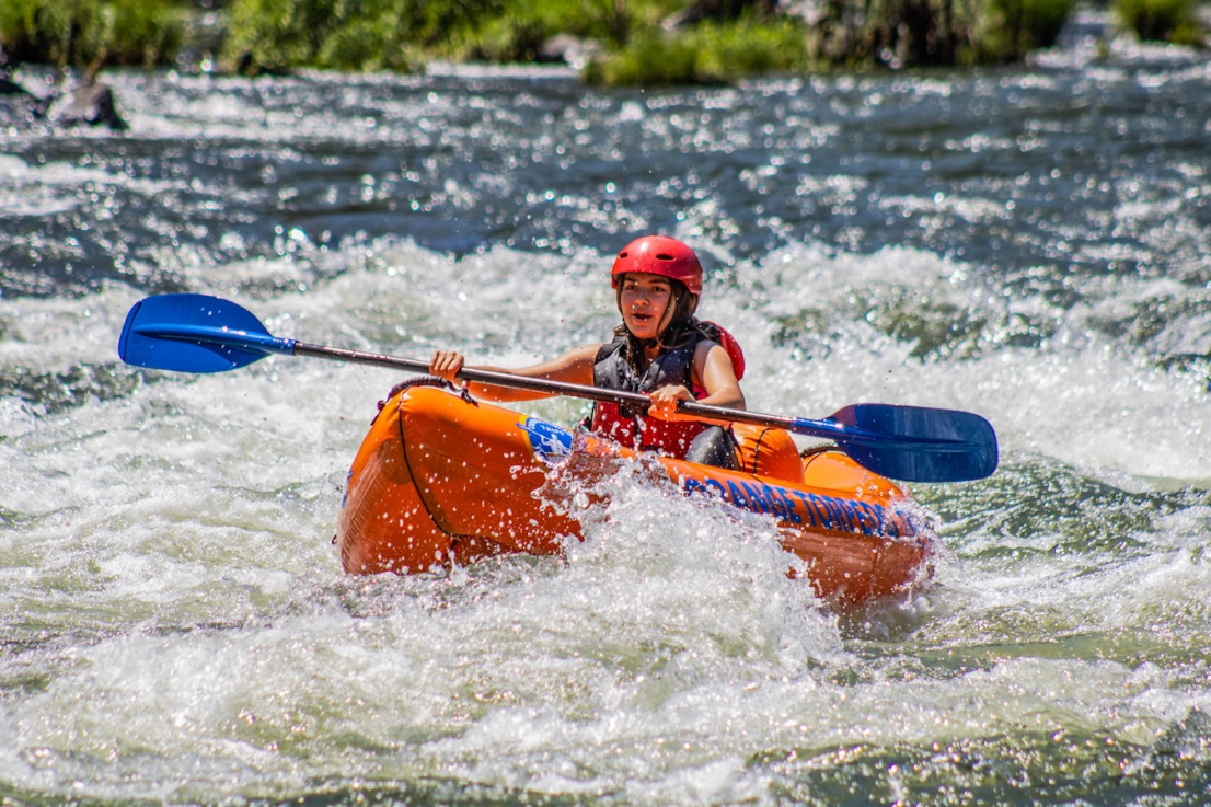 Teen girl inflatable kayaking a rapid on the Rogue River
