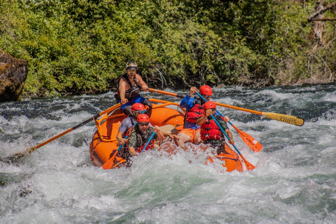 Orange Torpedo Trips raft in a steep whitewater rapid on the North Umpqua River