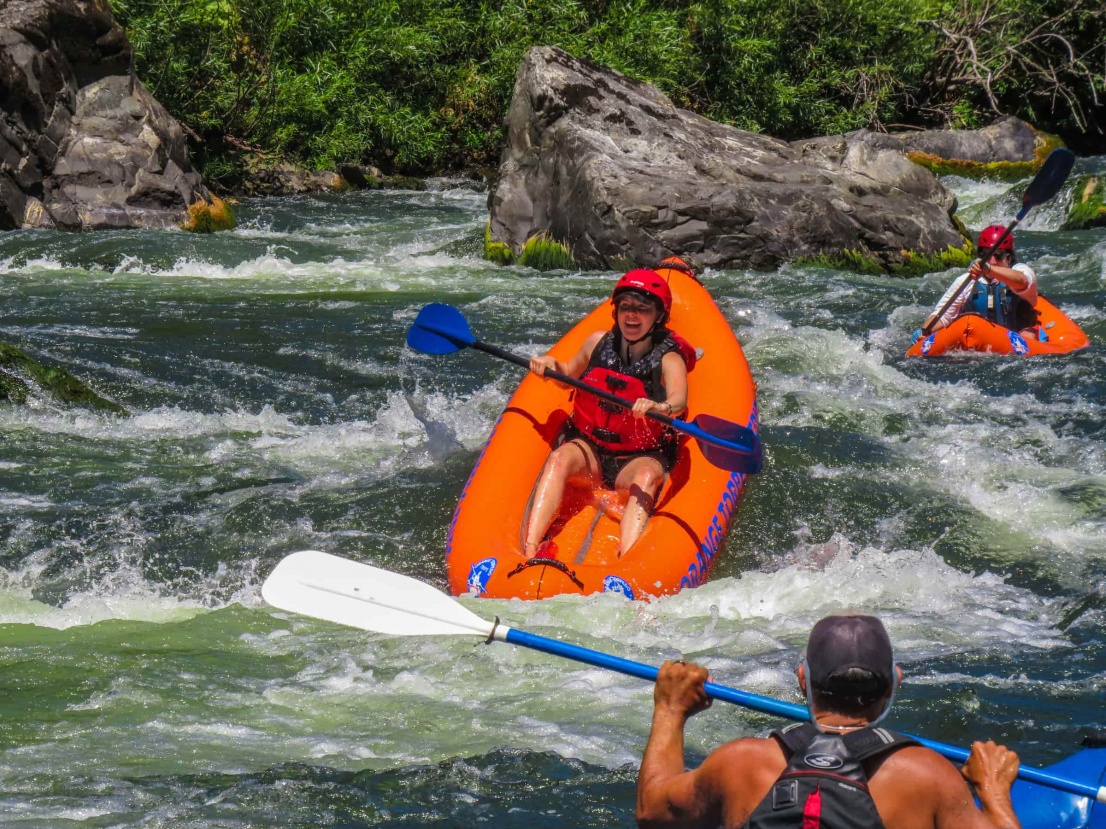 Lady having fun kayaking China rapid on the Rogue River