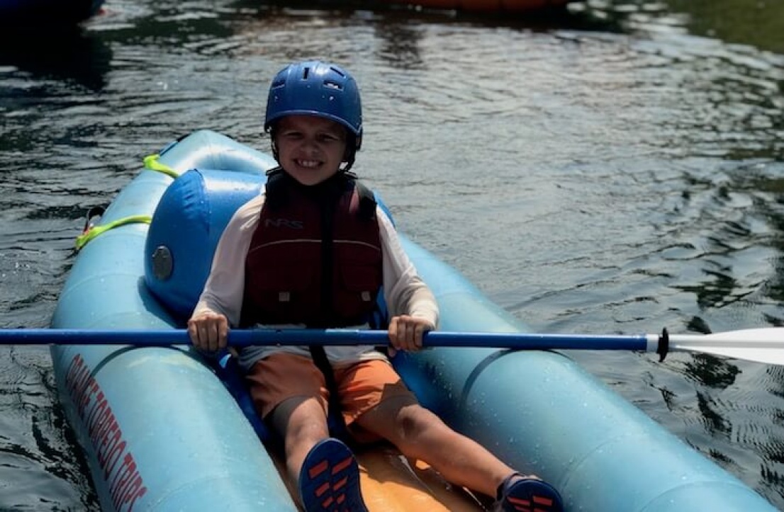 Kid in inflatable kayak on the Rogue River