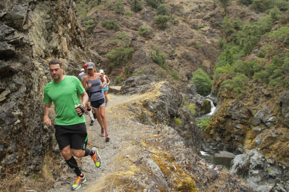 Group running past inspiration point on the Rogue River trail