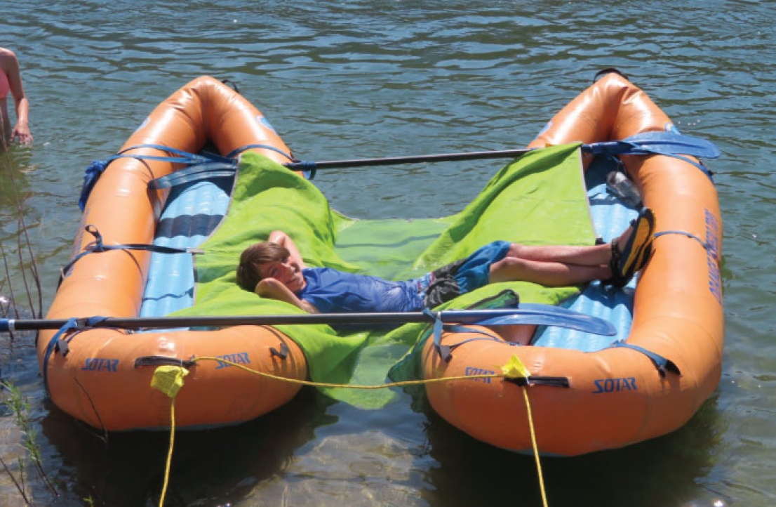 Kid relaxing in inflatable kayak on the Salmon River
