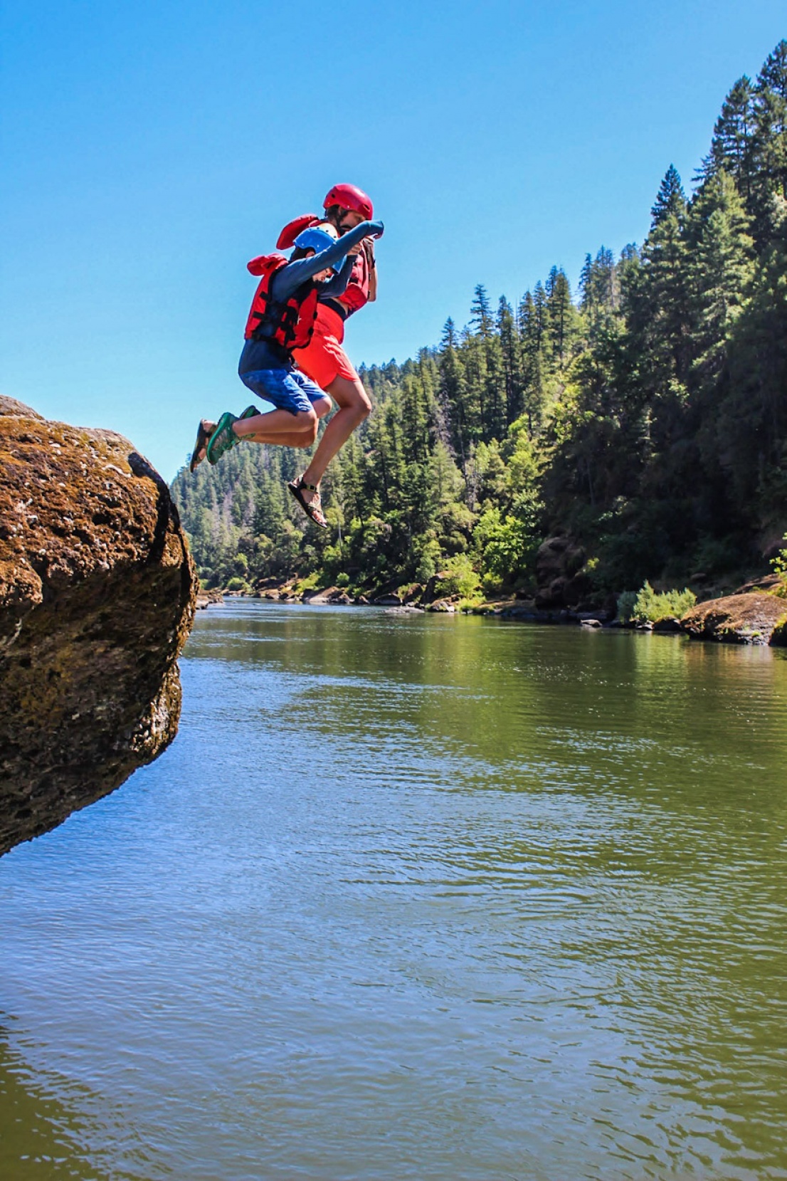 Mom and son jumping into the Rogue River