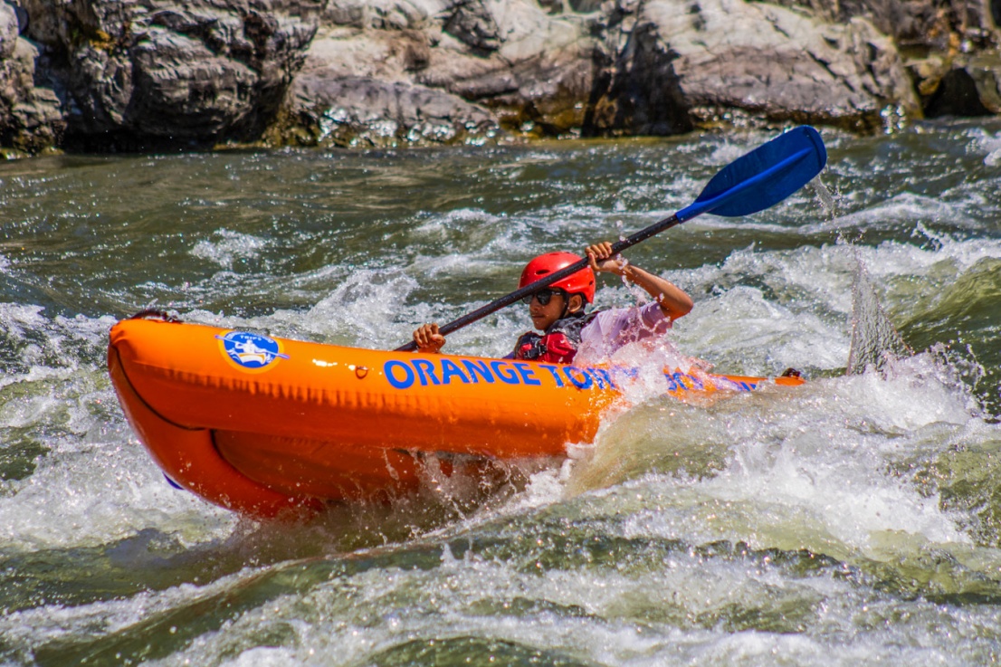 Boy inflatable kayaking lower Galice rapid on the Rogue River