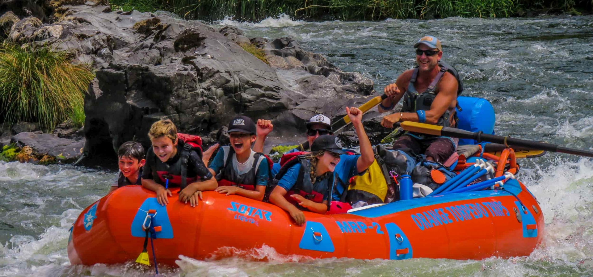 Kids group having fun whitewater rafting on the Rogue River